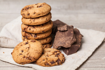 Chocolate chip cookies with chocolate parts on wooden table