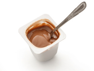 Open yogurt in pot with metal spoon
