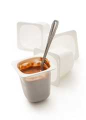 Open yogurt in pot with metal spoon