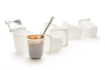 Open yogurt in pot with metal spoon