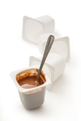 Open yogurt in pot with metal spoon