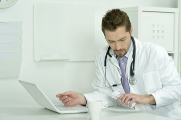 Medical doctor working with laptop