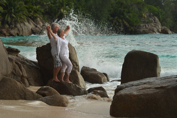 elderly couple rest at tropical beach