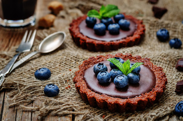 chocolate tartlets with chocolate filling and fresh blueberries