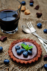 Obraz na płótnie Canvas chocolate tartlets with chocolate filling and fresh blueberries