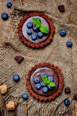 chocolate tartlets with chocolate filling and fresh blueberries