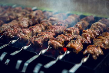 large number of preparing kebabs on the grill