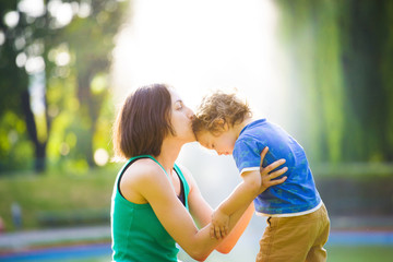 Mother kissing baby.