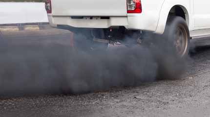 Air pollution from vehicle exhaust pipe on road