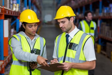 Workers looking at clipboard