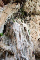The cliffhangers assault a rock on the island Railay in Thailand