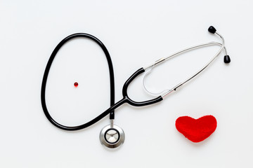 stethoscope on white background with plush heart top view