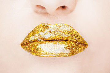 Close-up shot of woman lips with glossy glitter lipstick 
