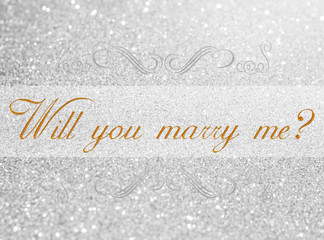will you marry me? on white silver glitter bokeh abstract background