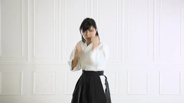 beautiful woman wearing a hakama engaged in Jiu Jitsu 