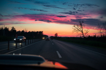 Obraz premium Drive car at beautiful sunset. Nature landscape