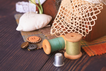 Fototapeta na wymiar Spool of thread, a thimble and a box with needlework