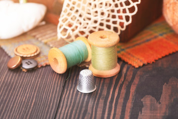 Fototapeta na wymiar Spool of thread, a thimble and box with needlework