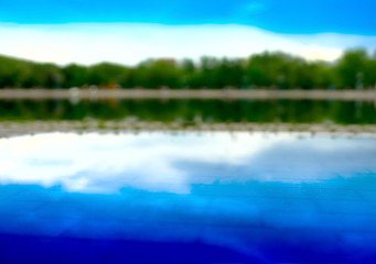 Fototapeta na wymiar Horizontal forest reflection on street pool bokeh background