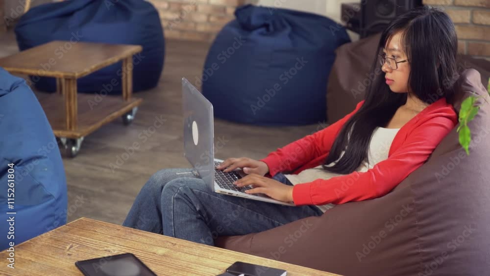 Poster young asian girl chatting in social net on computer use wifi. student or worker work with office equ