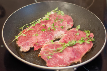 beef steak fried in a skillet with timyanom
