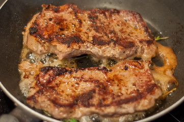 beef steak fried in a skillet with timyanom
