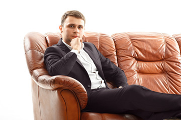Thinking businessman  holding his chin