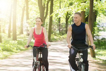 Naklejka premium Young Couple Riding Bicycles