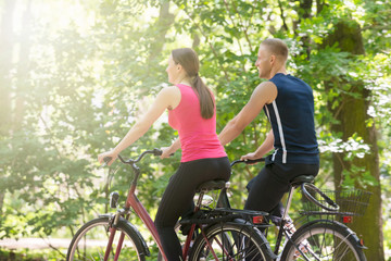 Naklejka premium Young Couple Riding Bicycles