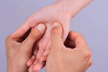Acupressure. Therapist doing healing treatment treatment on woman's hand . Alternative medicine, pain relief concept