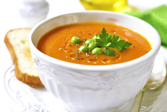 Carrot creamy soup with green pea.