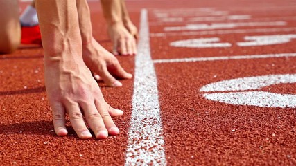 Track runners putting hands at starting line - Powered by Adobe