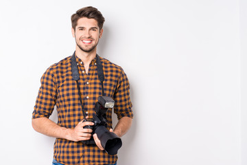 Happy handsome man with professional camera isolated on white ba