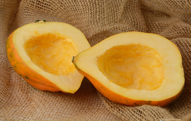 Raw uncooked Cleaned acorn squash halves on burlap