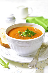 Carrot creamy soup with green pea.