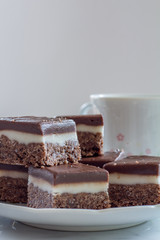 Chocolate Peppermint Slice on a Plate with a Cup of Tea with Copy Space