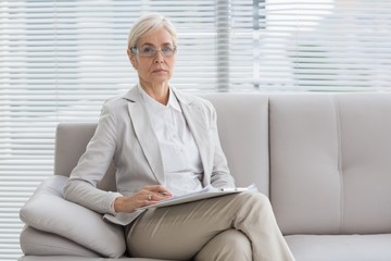 Portrait of therapist sitting on sofa
