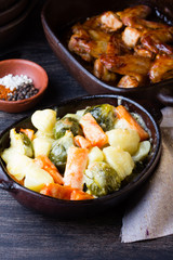 Rustic baked vegetables in clay bowl