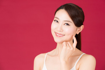 attractive asian woman isolated on red background