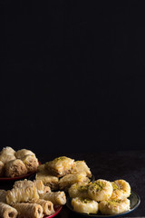 Variety of Baklava Dark on Dark Background Vertical with Copy Space