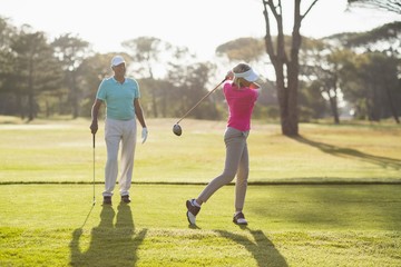 Fototapeta premium Mature golfer playing by man