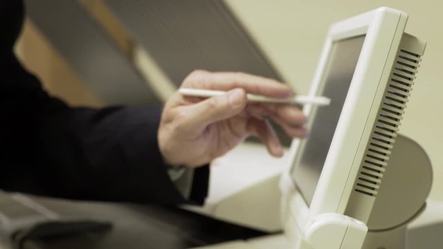 businessman pressing the touch screen of a large printer 4k