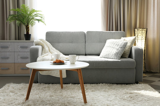 Living room design interior with sofa and round table
