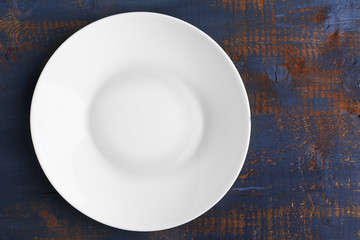 Empty plate on wooden background, top view