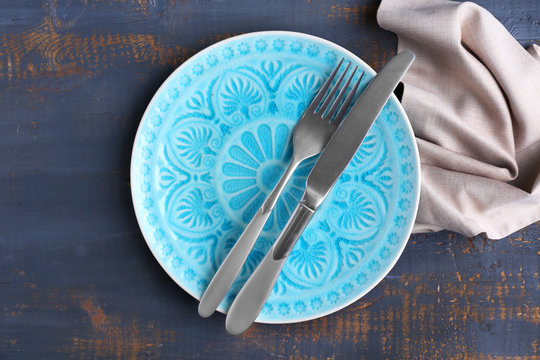 Set of dinnerware on wooden table