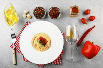 Composition of spaghetti in white plate on gray background