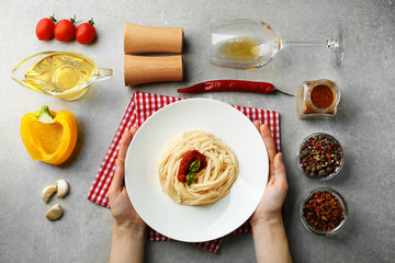 Composition of spaghetti in white plate on gray background