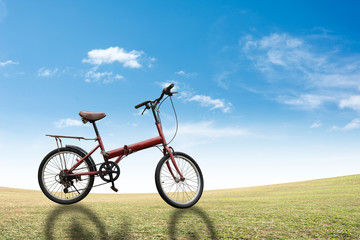 Fototapeta na wymiar Bike on grass sky background.