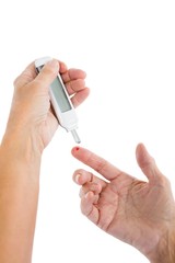 Cropped image of woman using blood glucose monitor
