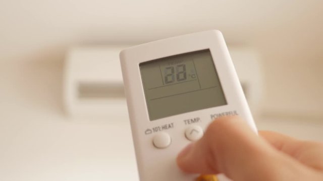 Cooling down room by changing temperature on air conditioner 4K 2160p UHD video - Changing room temperature with AC remote controller 4K 3840X2160 UHD footage 